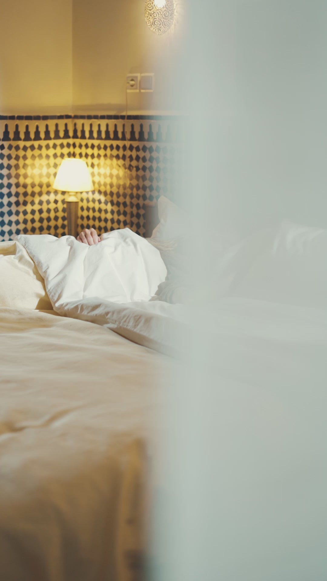 Load video: Woman waking up in riad in Morocco.  Serene space. We see her begin to take a shower and use Marrok black soap. Suddenly we see her in the chaos and colour of the medina and the souqs, meeting shopowners, smelling spices, learning about crafts, seeing traditional skincare, exploring the laneways. There&#39;s so much going on.  We cut back to her room in the riad, where it is again quiet, she uses the soap to lather, then rinses it off, then scrubs with an exfoliation mitt.  She finishes wearing a white robe, looking fresh and relaxed and at east.
